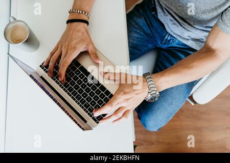 Top view of man working on laptop at home Stock Photo
