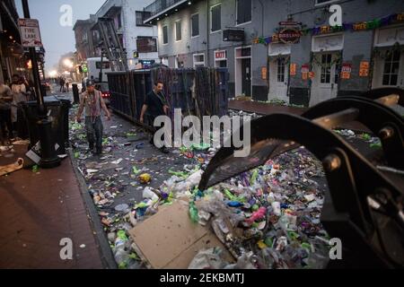 Bulldozer cleaning Trash-filled streets late night morning after Mardi Gras, New Orleans, Louisiana, USA. Bourbon Street. Stock Photo