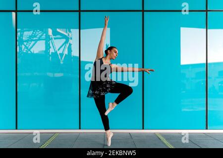 Graceful female dancer practicing against modern building Stock Photo