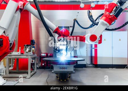 Automatic robots welding metal in factory Stock Photo