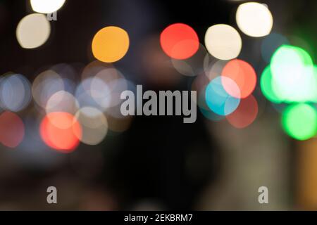 Defocused image of multi colored illuminated lights in city at night Stock Photo