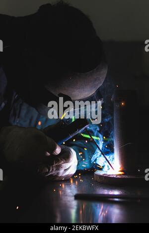 Male welder in protective work wear working at workshop Stock Photo
