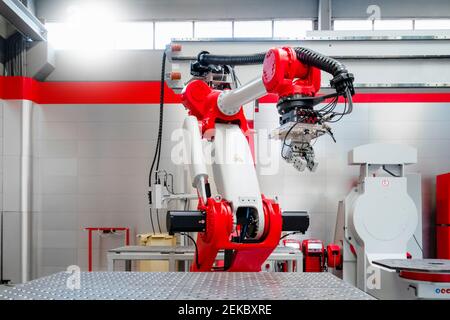 Red and white automatic welding robot in factory Stock Photo