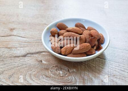 salty baked almond seed batch on cup Stock Photo