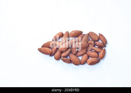 salty baked almond seed batch on white background Stock Photo