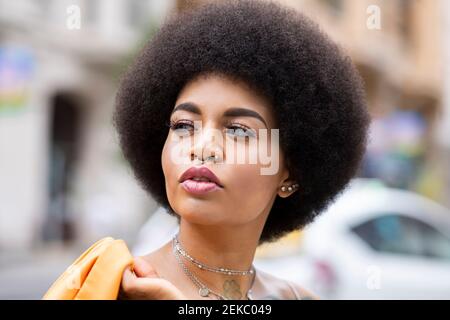 Afro woman contemplating outdoors Stock Photo