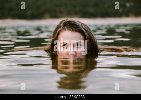 Young woman swimming in lake Stock Photo