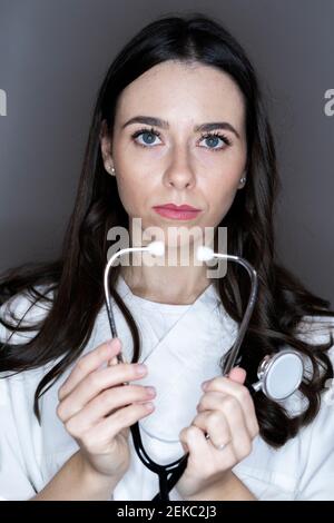 Female doctor with stethoscope in studio Stock Photo
