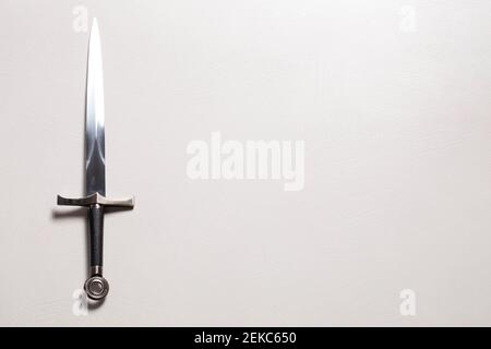 A Medieval Sword Isolated on a White Textured Background Stock Photo