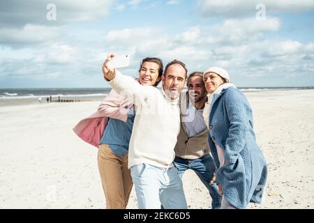 Group of friends taking selfie at beach Stock Photo