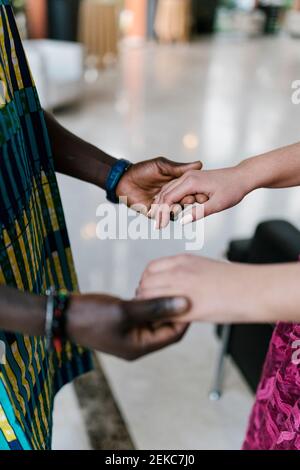 Couple holding hands while standing at banquet Stock Photo