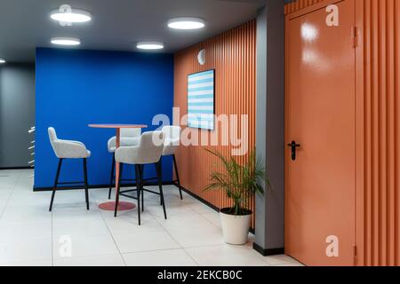 Table and chair against blue wall in office Stock Photo