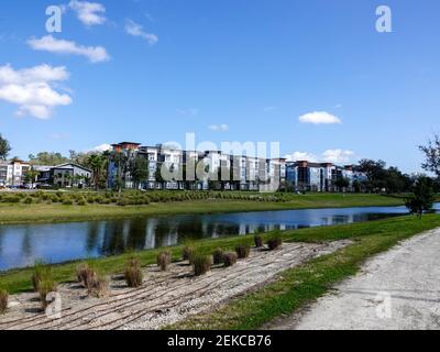 Apartment development with nicely landscaped water and recreation area for walking, green space, Gainesville, Florida, USA. Stock Photo