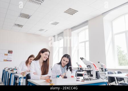 Students working in science lab classroom Stock Photo