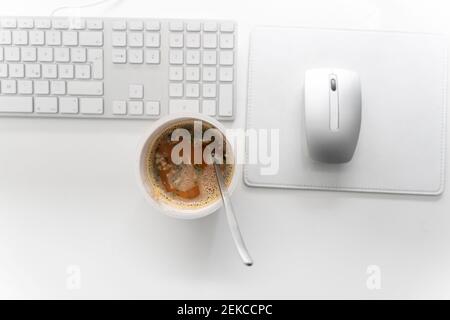 Instant noodles cup with computer keyboard and mouse on desk at home office Stock Photo