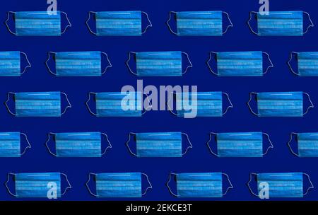 Pattern of protective face masks against blue background Stock Photo
