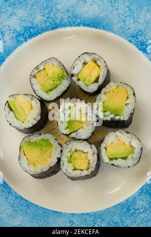 vegetarian Sushi with avocado on white and blue plate Stock Photo