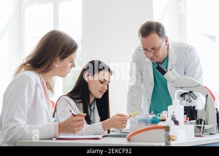Students and teacher working in science class Stock Photo