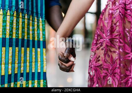 Young couple holding hands while standing at banquet Stock Photo