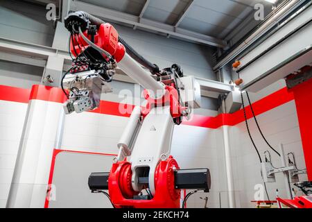 Low angle view of industrial welding robot arm in factory Stock Photo