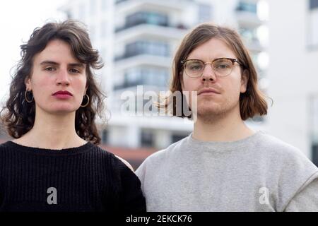Serious couple against building Stock Photo