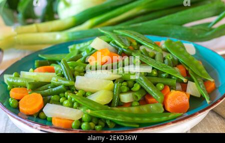 fresh cooked spring vegetables on a plate Stock Photo