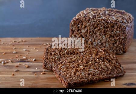 sliced sunflower seed bread on a wooden board Stock Photo