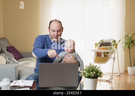 Dad and his kids have an online video call on Christmas. Chat with distant families during the pandemic. Be safe during winter break Stock Photo