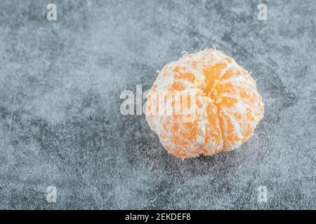 Peeled tangerine or mandarin fruit isolated on a gray background Stock Photo