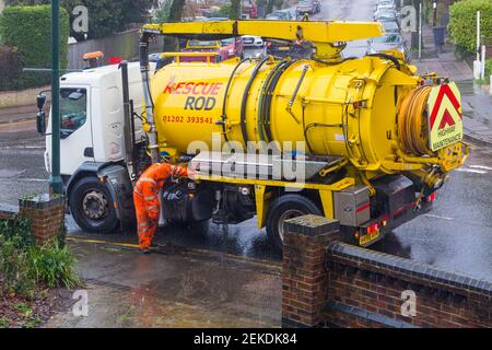 Rescue Rod highway maintenance checking/clearing drains in torrential rain  at Bournemouth, Dorset UK in February Stock Photo - Alamy