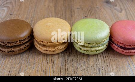 fresh colorful macarons lined, raspberry, chocolate, hazelnut, pistachio Stock Photo