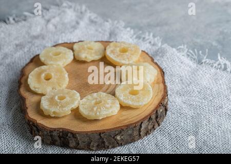 Slices of dried pineapple on a wooden board Stock Photo