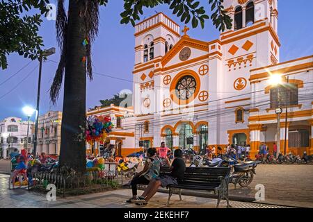 Bolivians in front of Trinidad Cathedral at sunset in the colonial city centre of Trinidad in the Amazon, Cercado Province, Beni Department, Bolivia Stock Photo