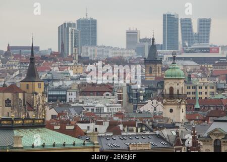 Pankrác skyscrapers raised behind the historical centre of Prague pictured from the Hanavský Pavilon in Letná Park (Letenské sady) in Prague, Czech Republic. The skyscrapers pictured from left to right: Corinthia Hotel, City Empiria (Motokov Building), Panorama Hotel, City Tower and V Tower. The church of Saint Giles (Kostel svatého Jiljí), the New Town Hall (Novoměstská radnice) and the Astronomical Tower of the Clementinum (Klementinum) are seen from left to right in the foreground. Stock Photo