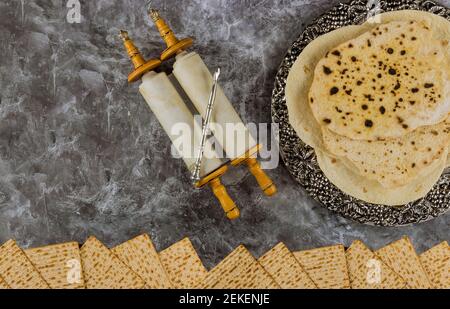 Passover day of great Pesach celebrating symbols holiday traditional Jewish family with kosher matzah, torah scroll Stock Photo