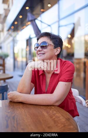 Beautiful happy mature woman in the sunglasses Stock Photo