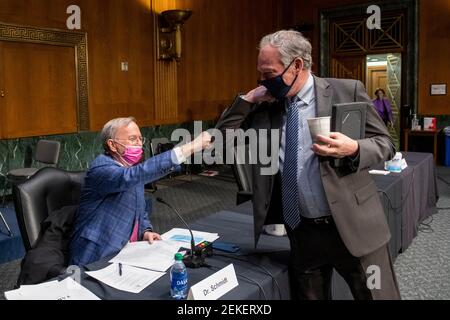 Dr. Eric E. Schmidt, Co-Founder, Schmidt Futures, left, is greeted by United States Senator Tim Kaine (Democrat of Virginia) prior to a Senate Committee on Armed Services hearing to examine emerging technologies and their impact on national security, in the Dirksen Senate Office Building in Washington, DC, Tuesday, February 23, 2021. Credit: Rod Lamkey / CNP | usage worldwide Stock Photo