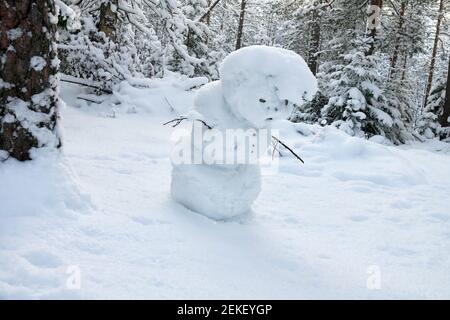 The Snow Maiden (snowman) makes his way through the snow-covered forest Stock Photo