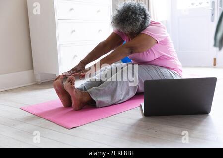 African american senior woman practicing yoga at home Stock Photo