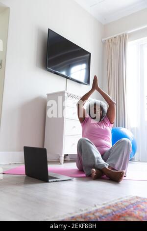 African american senior woman practicing yoga at home Stock Photo