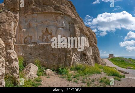 Murals of Necropolis, king burial site of ancient Persia. King on his horse carved into sandstone rock wall. Stock Photo