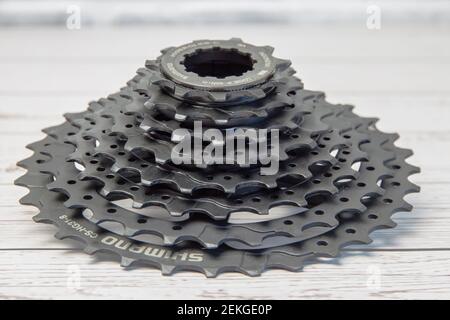 Krasnodar, Russia - February 12, 2021: New Shimano bicycle cassette in black on a wooden background Stock Photo