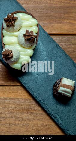 Chocolate easter egg on top of black stone Stock Photo