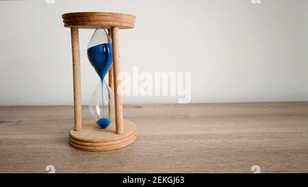 Hourglass or Sandglass. Catch the moment. Sands falling through hour glass. Pass of time and waste time concept. Stock Photo