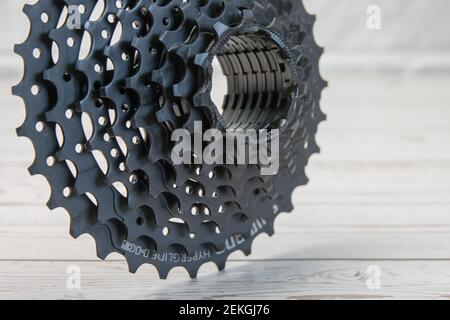 Krasnodar, Russia - February 12, 2021: The new black Shimano bike cassette stands with its teeth on the boards Stock Photo