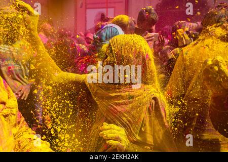 India Vrindavan Senior woman throwing colored powder at the widow's