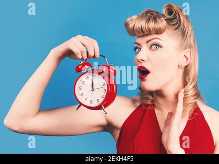 Time. Surprised woman with alarm watch. Pin up girl with alarm clock. Stock Photo