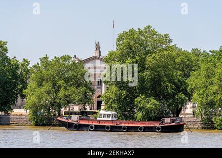 London, UK - June 25, 2018: Thames River with boat by Tate Britain art gallery building in downtown city in summer Stock Photo