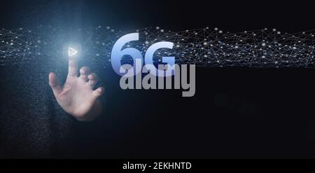 Hand Touch 6G network digital hologram and internet of things. 6G network wireless systems. 6G New generation telecommunication fast internet and tech Stock Photo