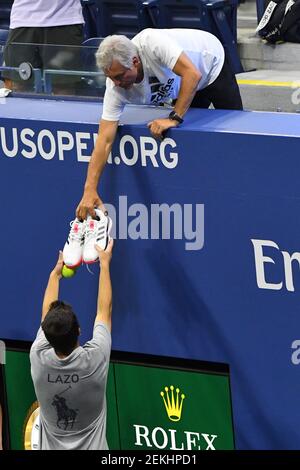 Sep 9, 2020; Flushing Meadows, New York,USA; A member of Dominic Thiem of Austria's camp hands a new pair of Thiem's shoes to a ball person during a changeover against Alex de Minaur of Australia (not pictured) in a men's singles quarter-finals match on day nine of the 2020 U.S. Open tennis tournament at USTA Billie Jean King National Tennis Center. Mandatory Credit: Robert Deutsch-USA TODAY Sports/Sipa USA